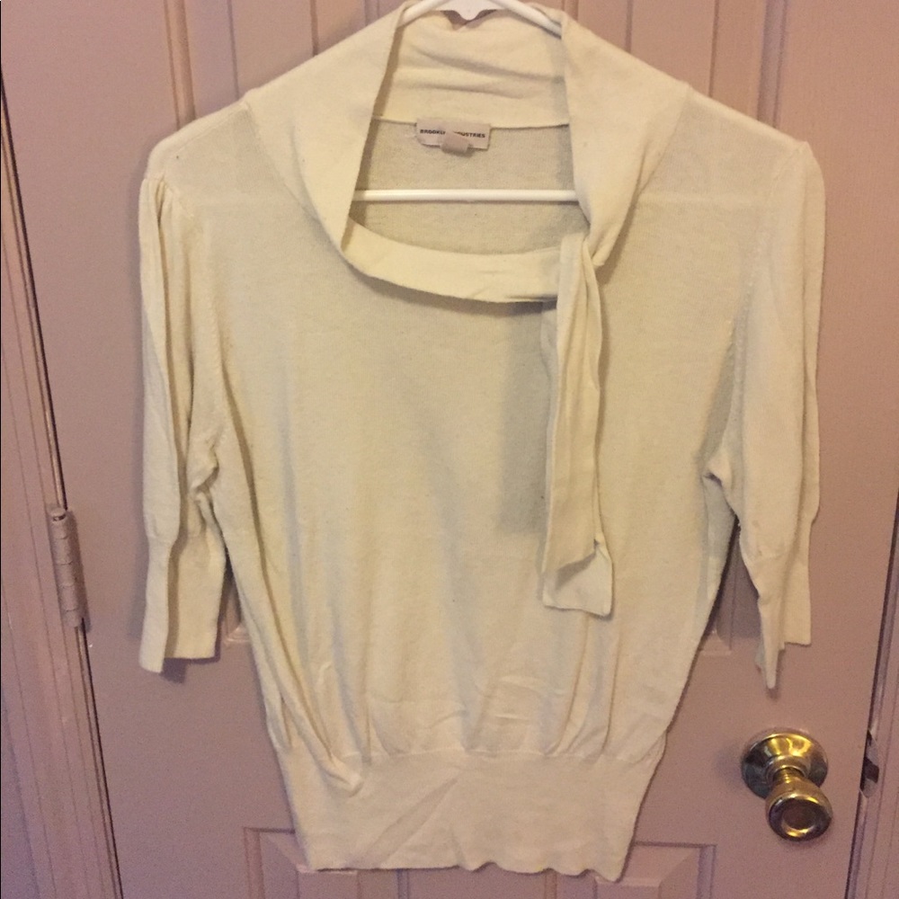 Light ivory sweater with jaunty neck tie